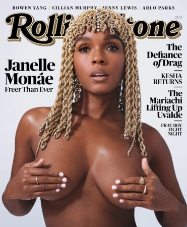 Janelle Monáe, photographed for Rolling Stone, strikes a direct pose. Her hair is styled with a decorative headpiece and jewelry.