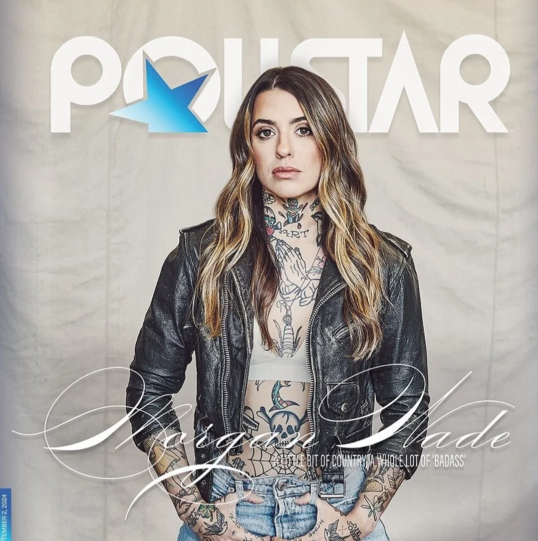 Magazine cover shot of Morgan Wade wearing black leather jacket, tattoos, and blonde hair against a textured off-white backdrop.