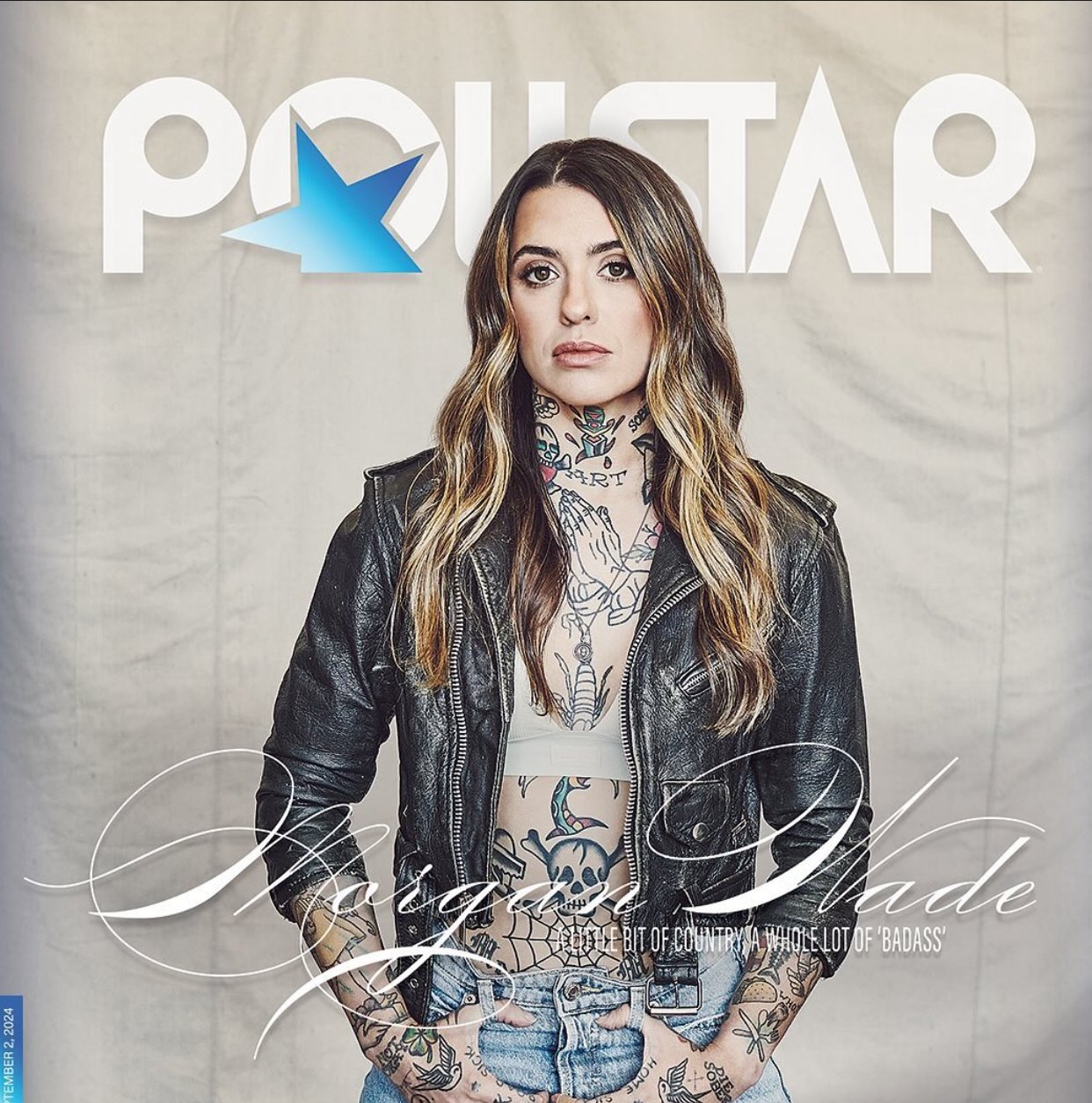 Singer Morgan Wade graces a magazine cover, showcasing her tattoos and wearing a leather jacket, set against a neutral background.