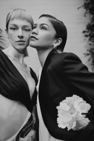 Monochrome portrait of Hunter Schafer and Zendaya posed close together, styled by hair stylist Kim Kimble.