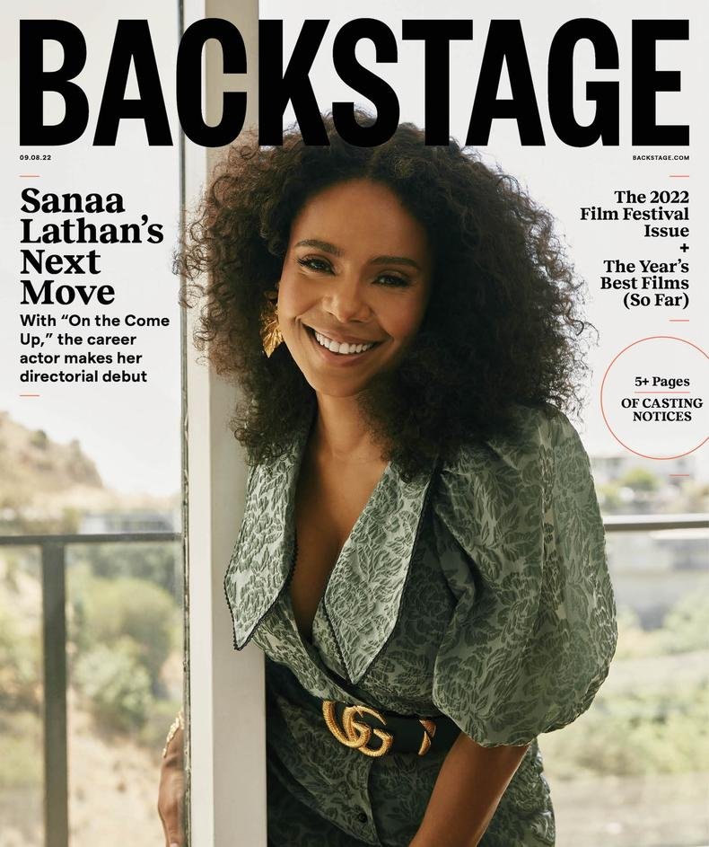 Sanaa Lathan on the cover of Backstage magazine, smiling and wearing a patterned green dress with a Gucci belt indoors.