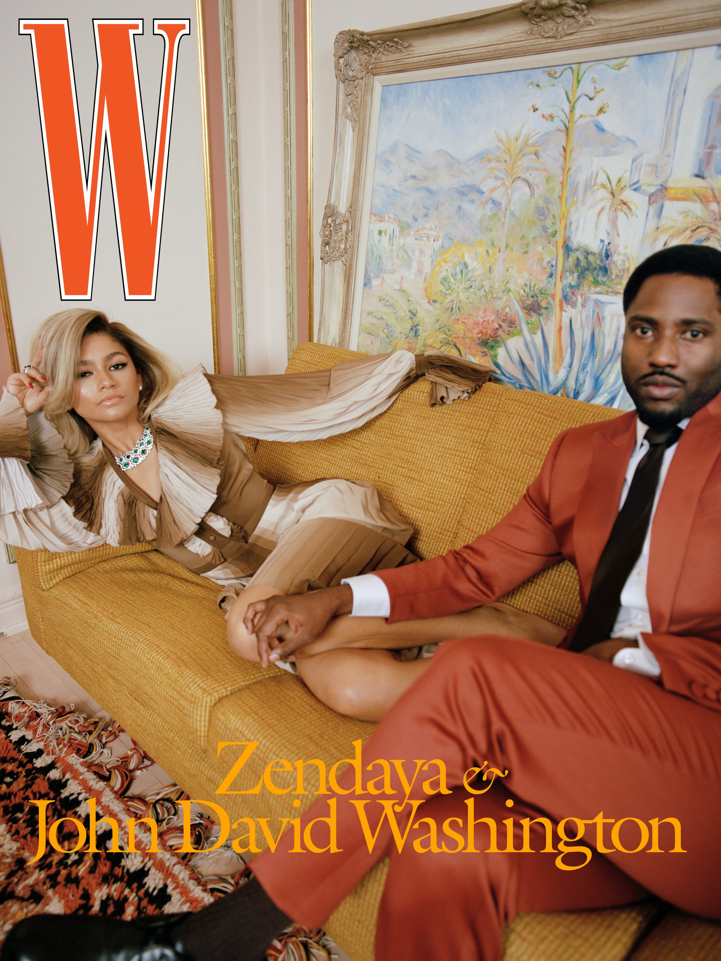 Magazine cover featuring Zendaya and John David Washington on a yellow couch with a painted backdrop in a portrait orientation.