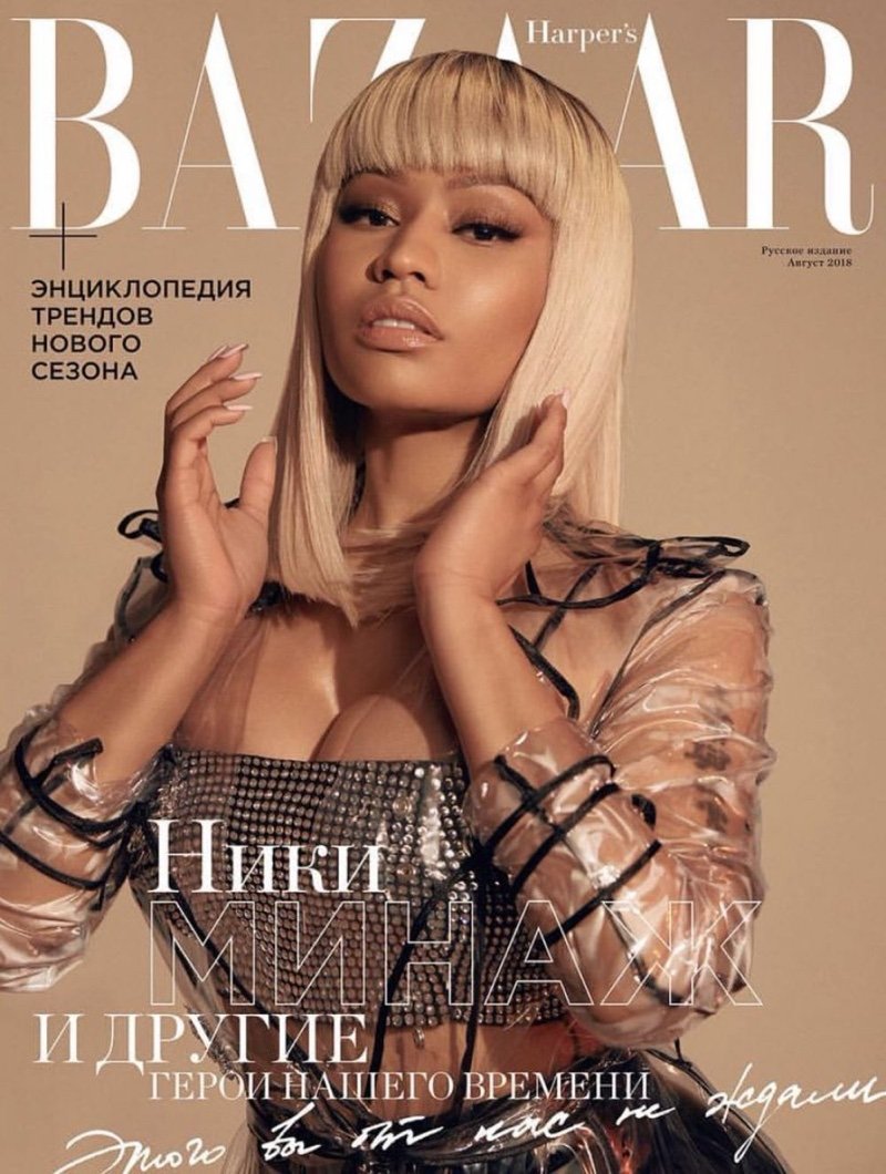 Magazine cover featuring Nicki Minaj wearing a transparent top and silver bustier, blonde wig, neutral makeup, and tan background.