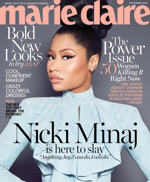 Magazine cover featuring Nicki Minaj wearing a light blue top, with magazine text overlay. Cropped view of the singer on a gray background.