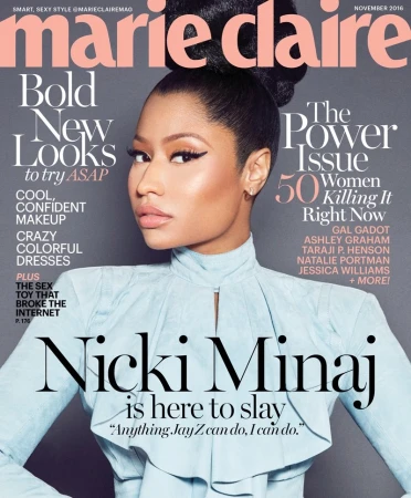 Magazine cover featuring Nicki Minaj wearing a light blue top, with magazine text overlay. Cropped view of the singer on a gray background.
