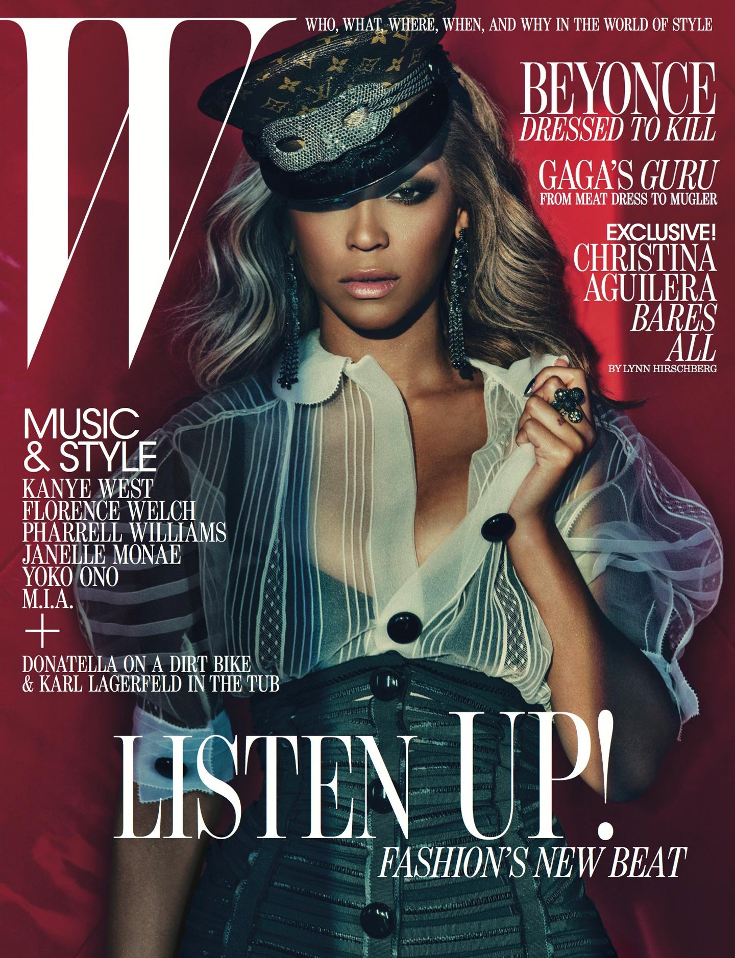 W Magazine cover featuring a portrait of a woman wearing a decorative hat and sheer top against a dark red background.