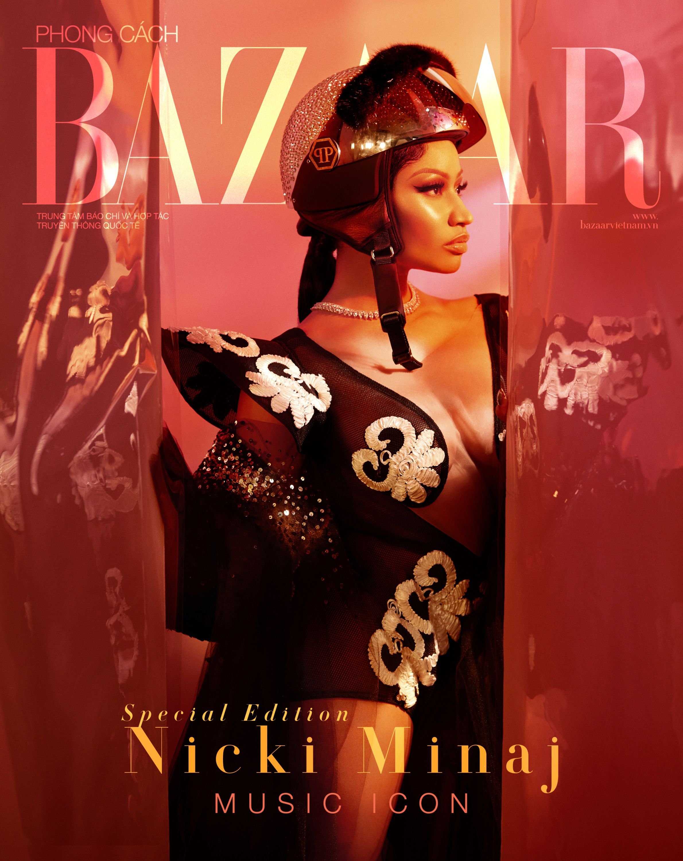 Portrait of Nicki Minaj on a magazine cover, wearing a sparkling motorcycle helmet, with the magazine title 'Bazaar' visible.