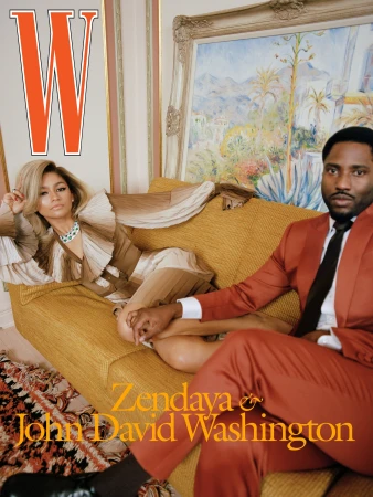 Magazine cover featuring Zendaya and John David Washington reclining on a yellow couch in front of a landscape painting.