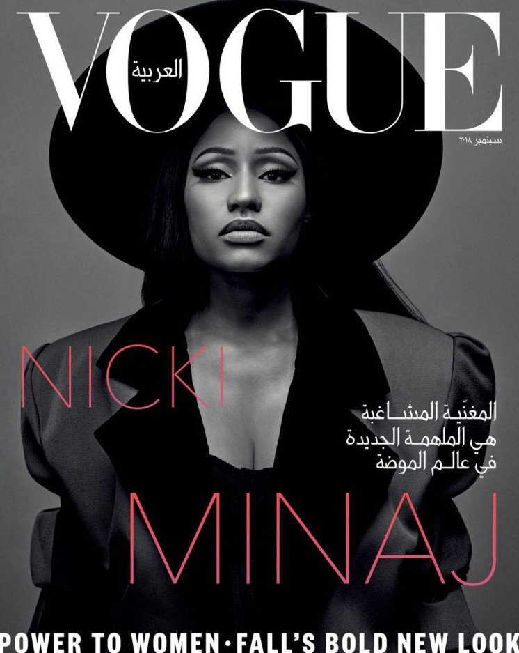 Vogue Arabia magazine cover featuring Nicki Minaj in a black hat and blazer, looking directly at the camera against a gray background.
