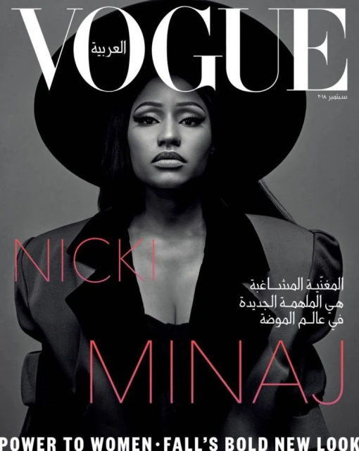 Vogue Arabia magazine cover featuring Nicki Minaj in a black hat and blazer, looking directly at the camera against a gray background.