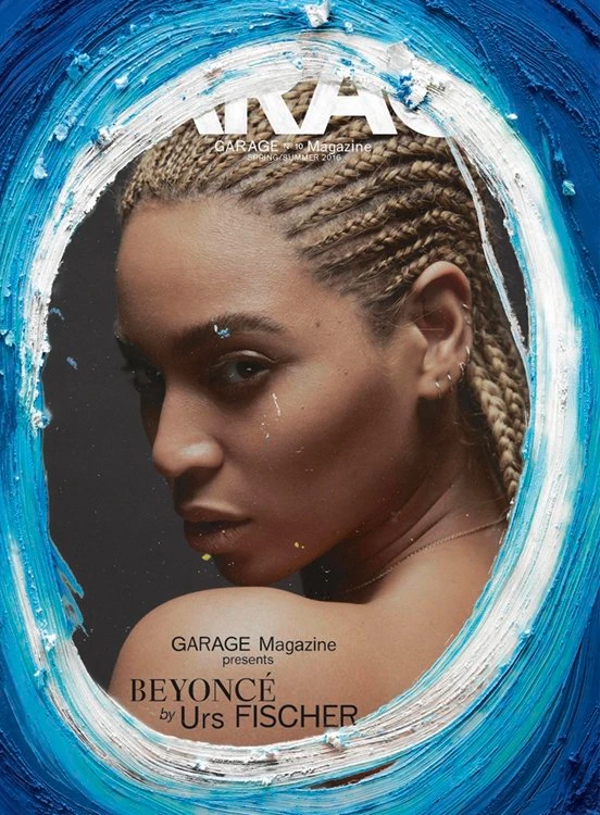 Close-up portrait of Beyonce with blonde box braids framed inside an expressive blue and white painted circular border.