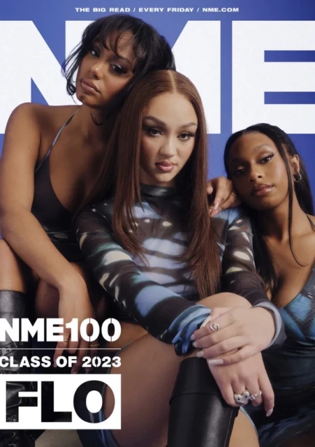 Three women pose for a magazine cover. They have long hair and wear printed tops. The NME logo and magazine edition are visible.
