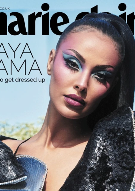 Marie Claire cover featuring Maya Jama with blue eyeshadow and dark hair. She wears a sequined top against a blurred light-blue background.