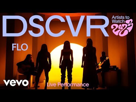 Music video performance by FLO, a female music group, featuring silhouettes against a vibrant orange backdrop and band members playing instruments.