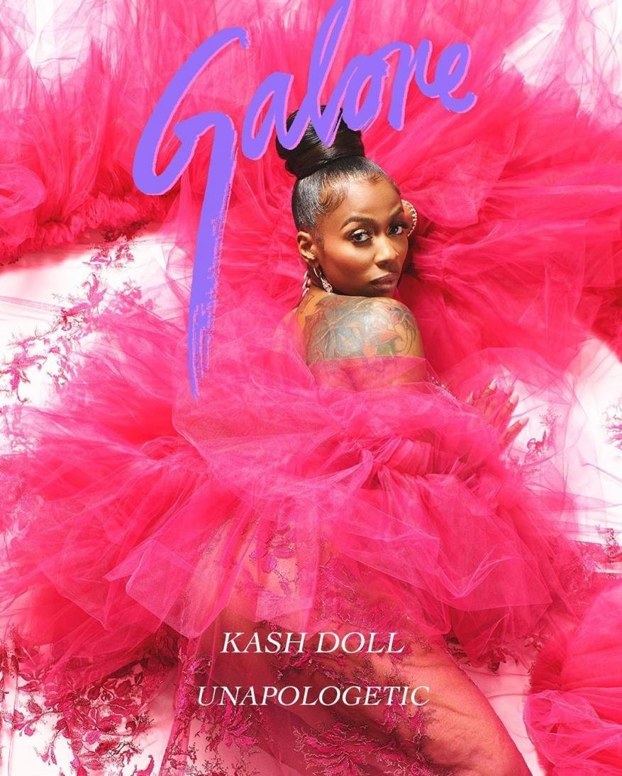 Portrait of an adult woman with a high bun posing in a pink, layered tulle dress. The image is an album cover for "Kash Doll".