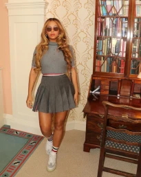 Beyonce wearing a grey pleated skirt and matching top with sunglasses, styled by Kj Moody in Los Angeles