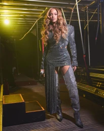Beyonce wearing a sparkly silver mini dress and thigh-high boots backstage styled by Kj Moody in Los Angeles.