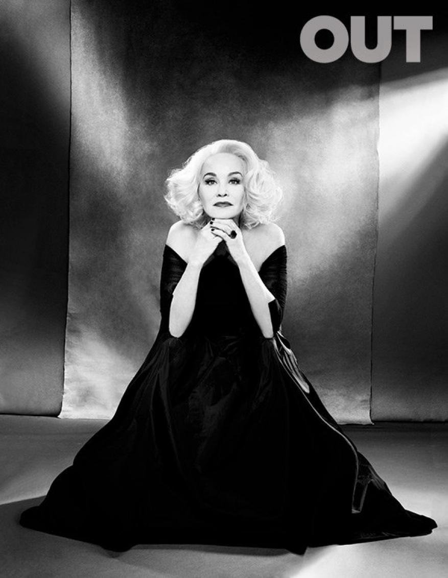 Jessica Lange in a black off-the-shoulder gown posing against a textured backdrop for an editorial portrait styled by Lauren Matos.