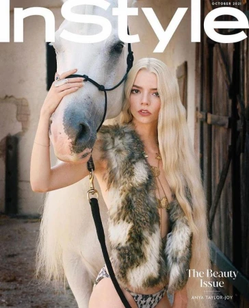 Anya Taylor-Joy poses on the cover of InStyle magazine with a white horse, wearing a fur stole and jewelry in an outdoor setting.