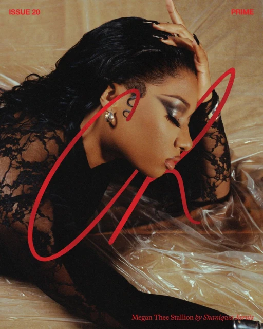 Magazine cover featuring a Black woman in a lace top with dark hair lying on plastic, makeup accentuates her eyes, shot in studio.