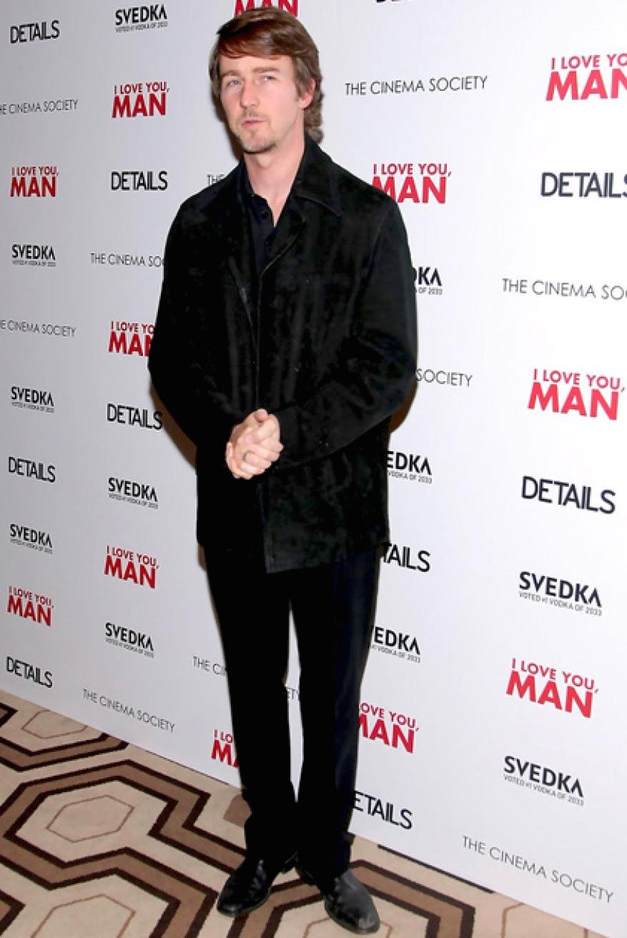 Full-length shot of Edward Norton in black suit at The Cinema Society screening of 'I Love You, Man,' standing in front of backdrop.