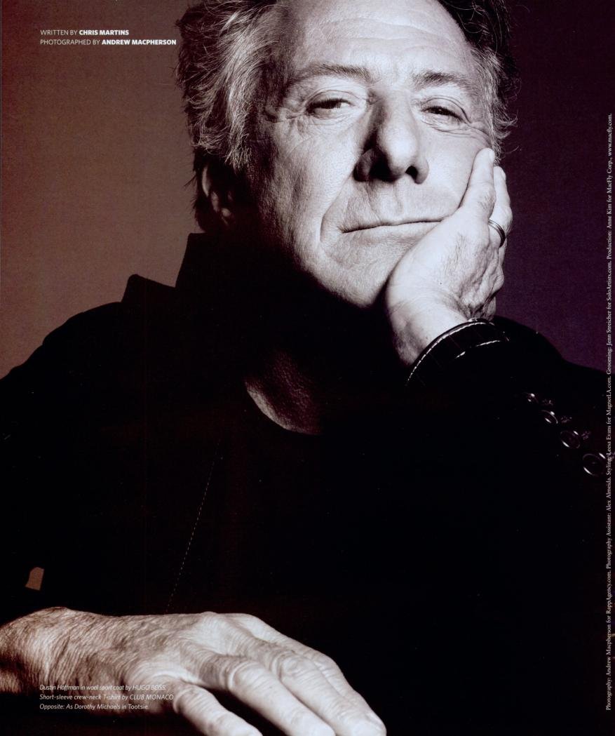 Dustin Hoffman portrait with hand on face, wearing a dark shirt against a muted gradient background in a dramatic studio lighting setup.