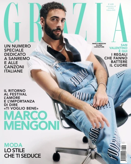 Marco Mengoni, Italian singer-songwriter, graces a magazine cover in denim overalls, sitting in an office chair against a clean white backdrop.
