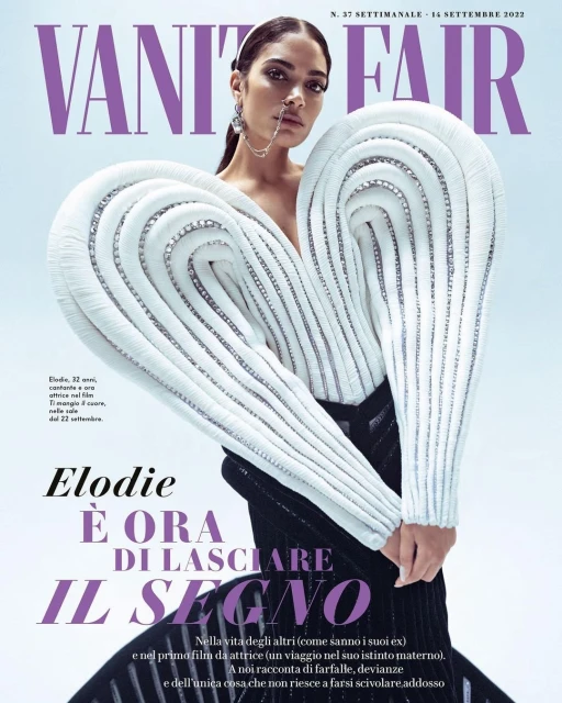 Vanity Fair magazine cover featuring a stylish adult female model with unique white dress, statement earrings, and minimal makeup.