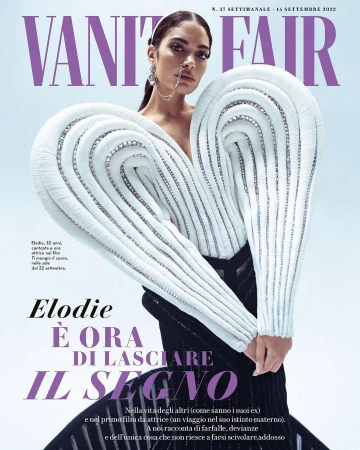 Vanity Fair magazine cover featuring a stylish adult female model with unique white dress, statement earrings, and minimal makeup.