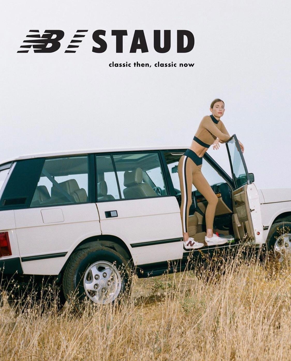 An adult woman in athleisure wear standing by an open SUV door on a grassy field against a bright sky with brand logos overhead.