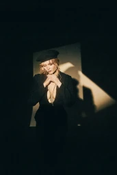 Woman in black beret and dark plunging blazer wearing long necklace styled by Maren Taylor in Los Angeles