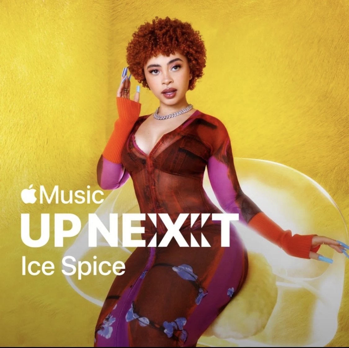 A portrait of rapper Ice Spice, with her signature orange curly hair, wearing a sheer patterned dress against a bright yellow background.