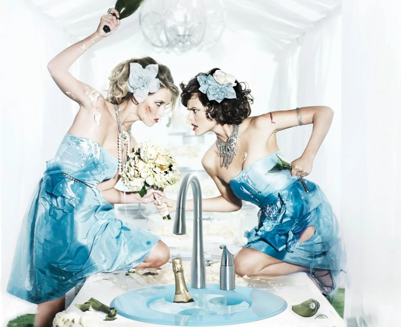 Two women in blue dresses, stained with cake, confront each other aggressively over a sink with a champagne bottle and knife.