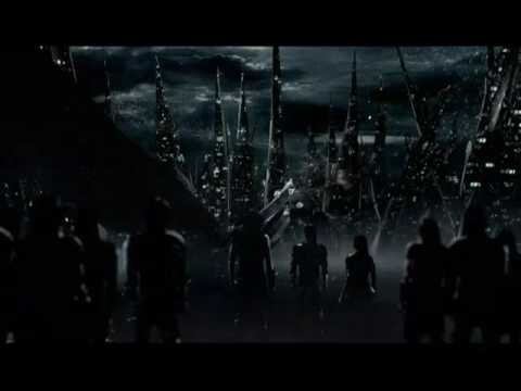 Dark futuristic scene of figures walking toward a metropolis with jagged skyscrapers and a cloudy, stormy sky. 