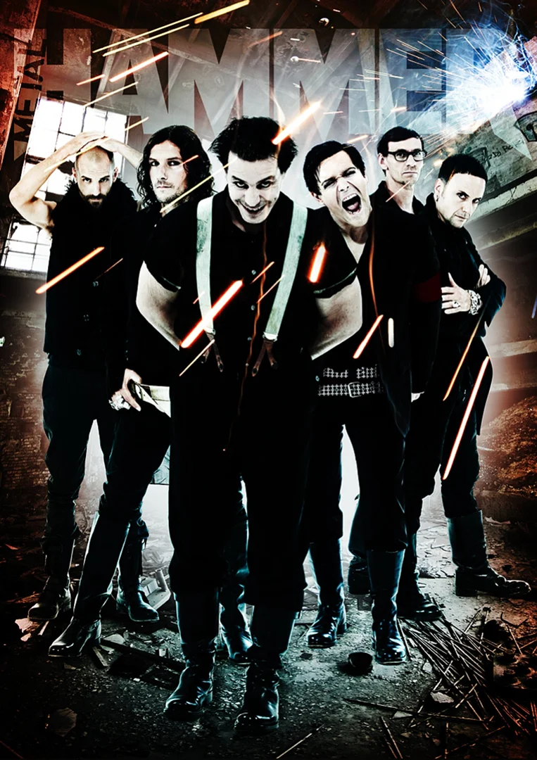 Group of six people in black clothing stand in an industrial setting with beams of light, evoking a metal music vibe.