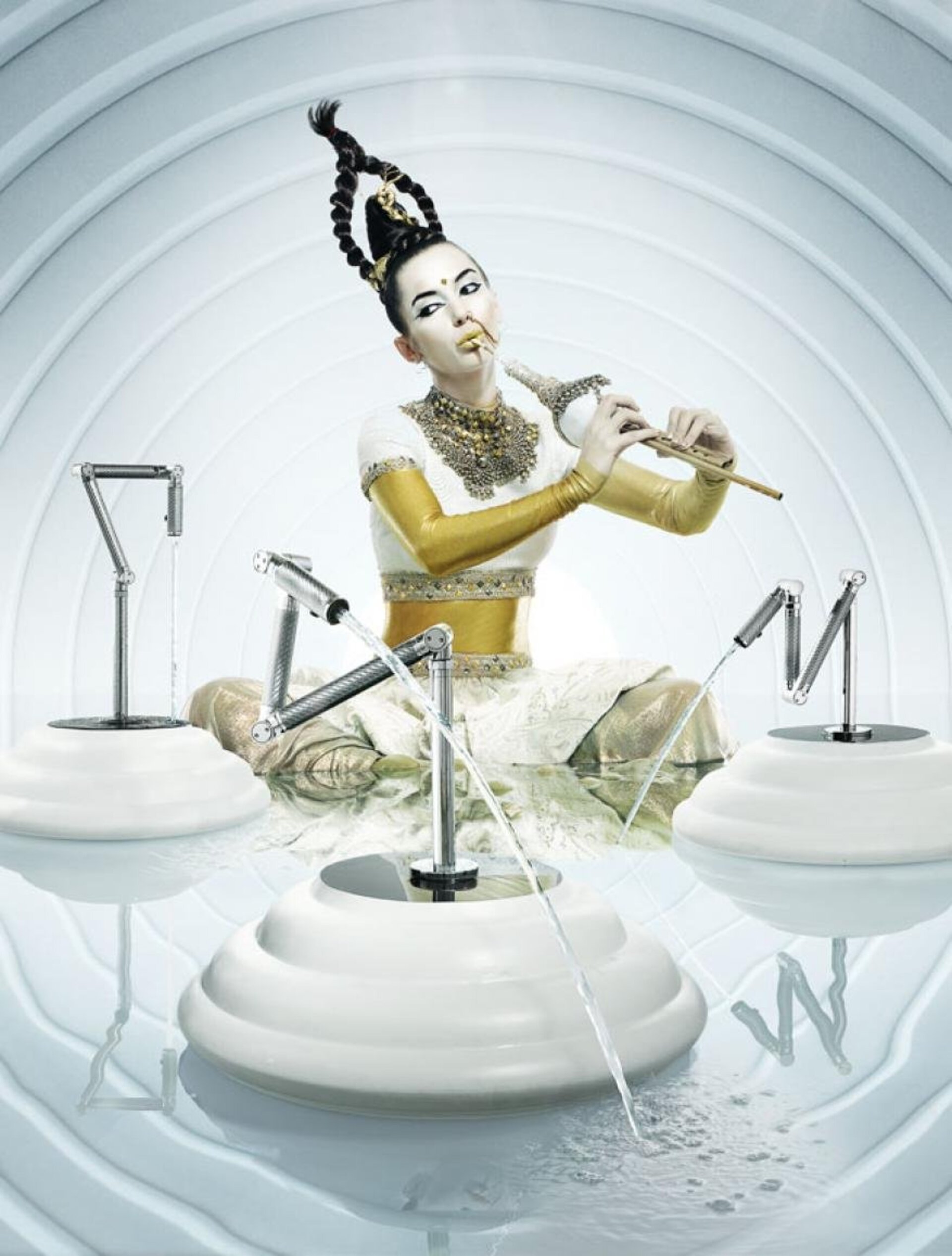 Asian woman with elaborate updo and makeup playing flute, seated in an artistic set with water features in an indoor environment.