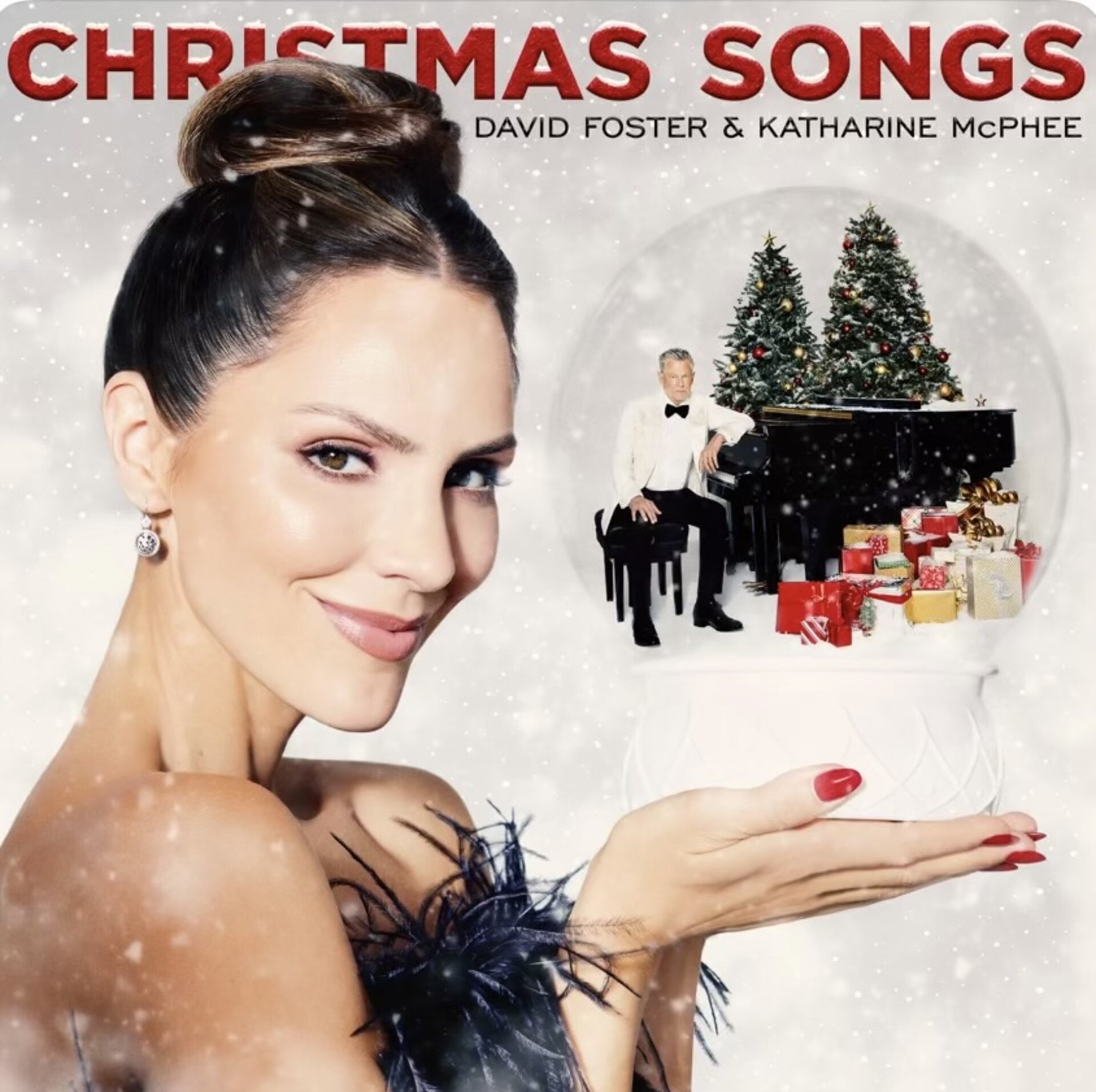 Katharine McPhee and David Foster are featured on a Christmas album cover with McPhee holding a snow globe.