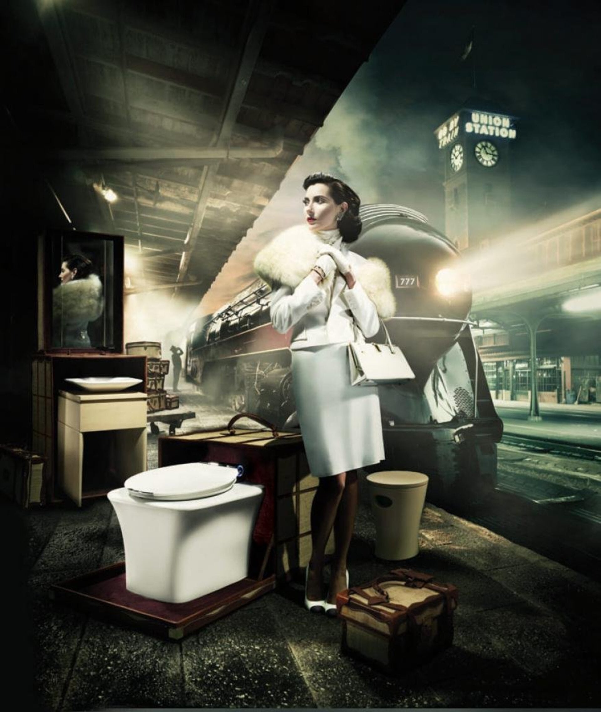 Elegant woman in vintage attire stands near luggage on a train platform next to a modern toilet, with a train and station backdrop.
