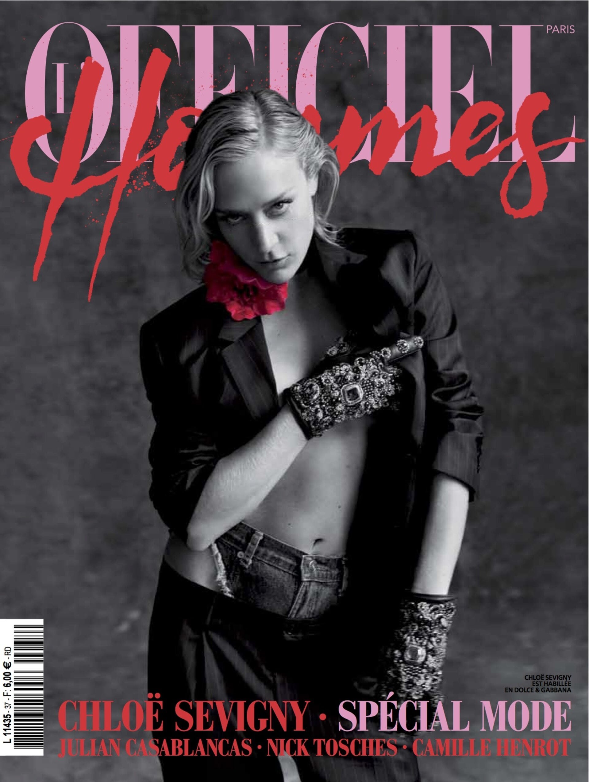 Fashion magazine cover featuring Chloe Sevigny wearing a black suit jacket and embellished gloves, posing against a smoky gray background.