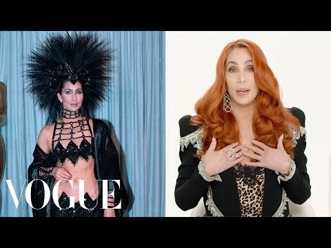 Two images side-by-side: Cher in a black feathered headdress and bra top; and Cher in a black jacket with curly red hair.