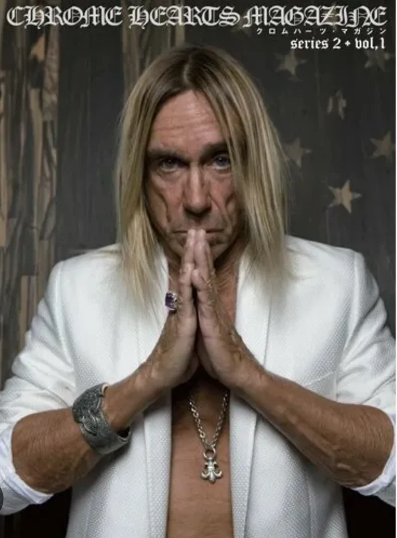 Iggy Pop in a white blazer with silver jewelry, hands in prayer pose, on the cover of Chrome Hearts Magazine Series 2, Vol. 1.