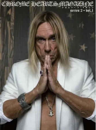 Iggy Pop in a white blazer with silver jewelry, hands in prayer pose, on the cover of Chrome Hearts Magazine Series 2, Vol. 1.