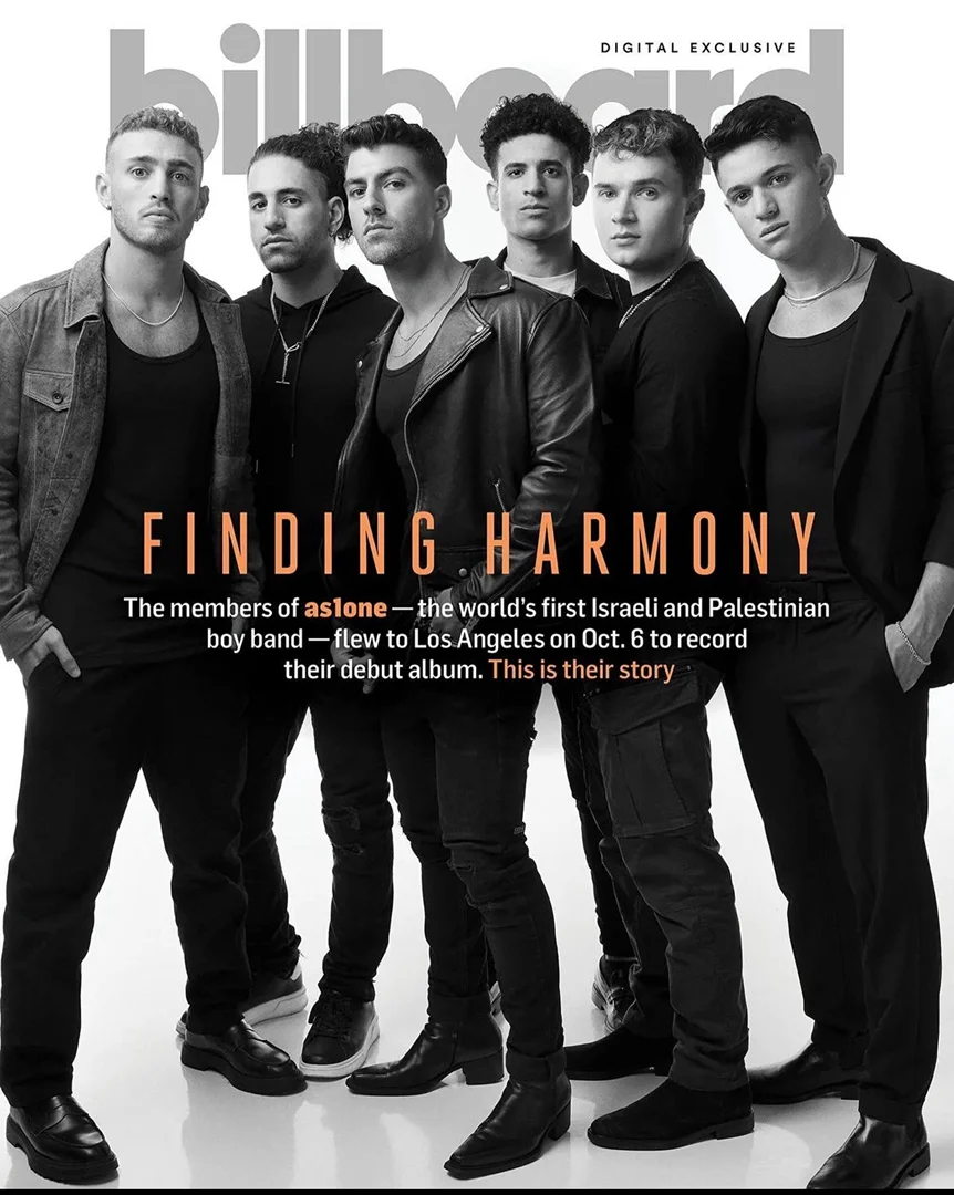 Group of six young adult men pose on the cover of Billboard magazine; they wear black clothing; the setting is a photo studio.