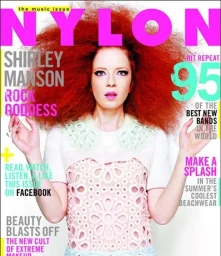 Shirley Manson with large red hair and white patterned top on Nylon magazine cover