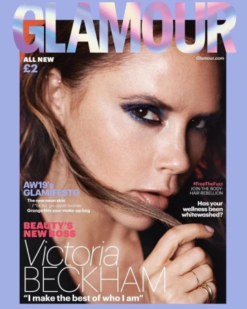 Glamour magazine cover featuring Victoria Beckham's portrait. She has smoky eye makeup and wears rings. The magazine has text headlines.