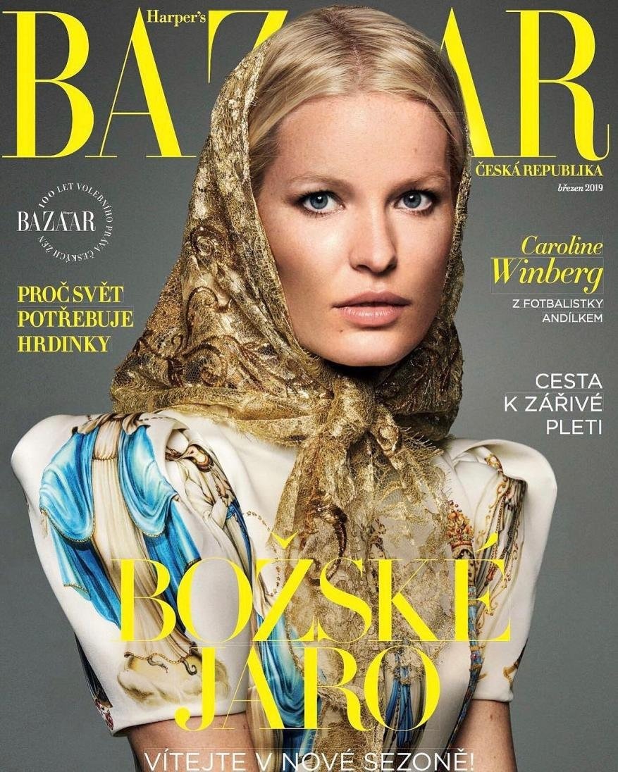 Model Caroline Winberg wearing a gold headscarf and printed white dress on a magazine cover