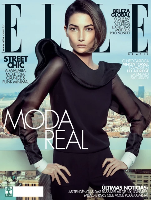 Elle Brasil cover featuring a model in a black top and pants, posing with hands on hips against an urban background. Magazine cover.