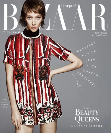 Model Alana Zimmer in a red and white patterned dress against a grey studio backdrop for a magazine cover styled by Mary Fellowes.