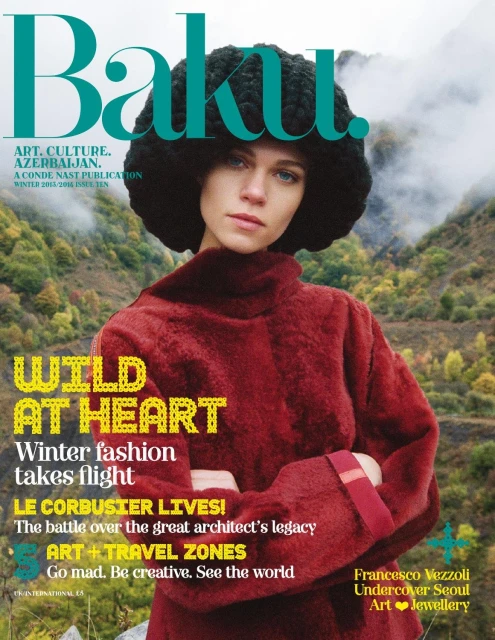 Magazine cover featuring a woman in a red coat and a black hat, with a background of mountains. Baku magazine, art, culture, Azerbaijan.