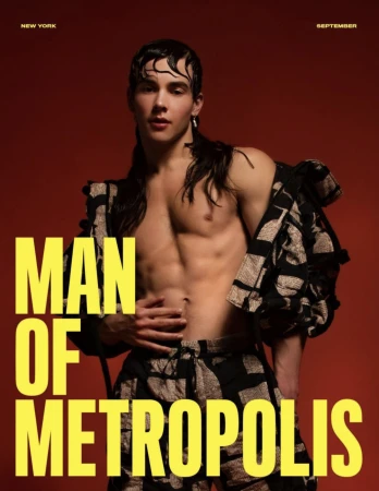 Shirtless male model with wet hair and patterned jacket against a deep red background with bold yellow text.